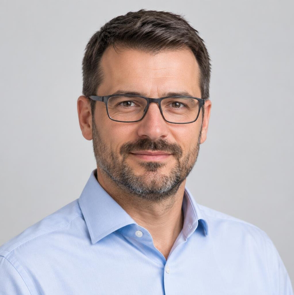 Studio portrait of a man with glasses and a beard
