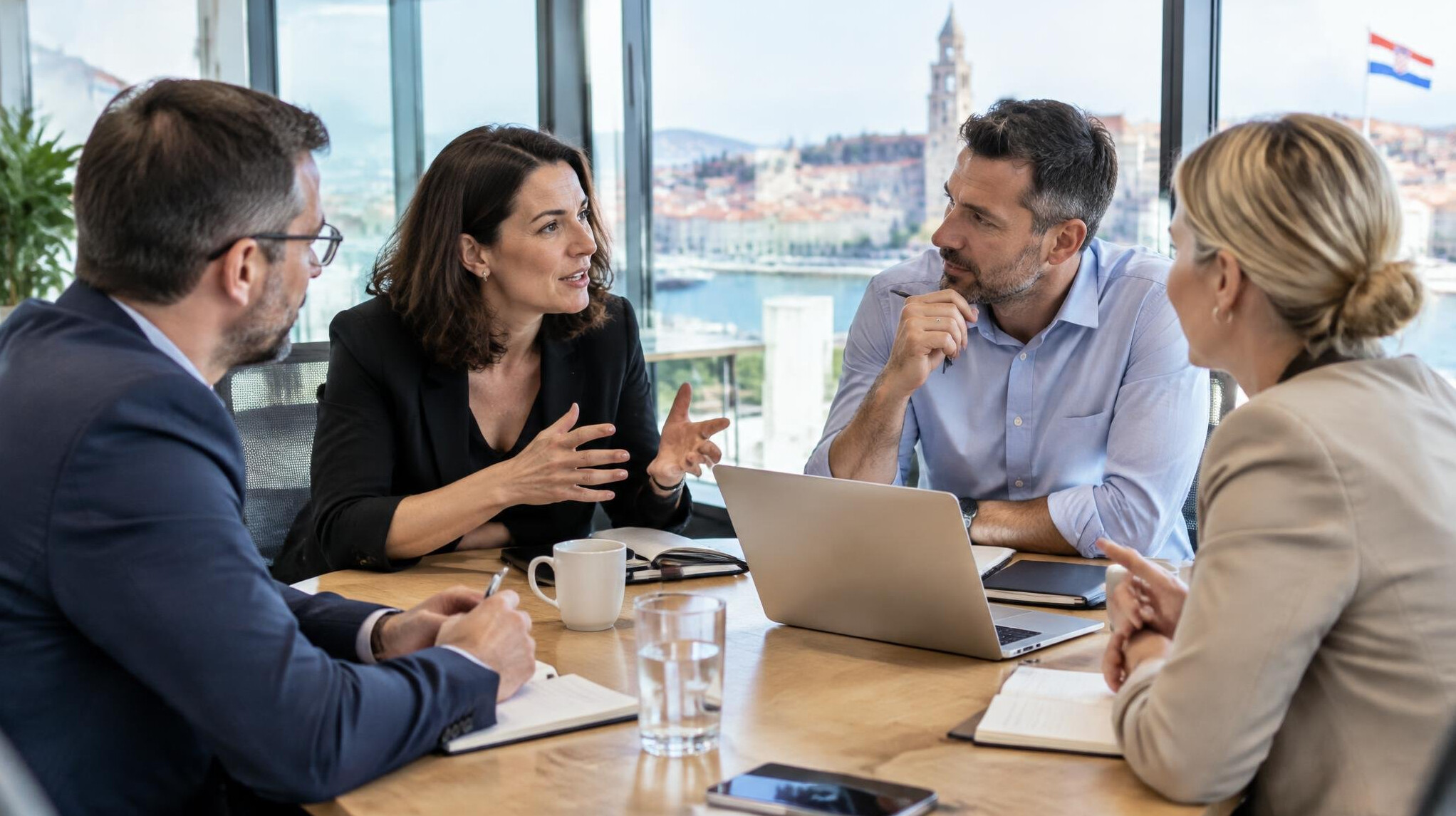 Group of colleagues having a discussion in a bright meeting room