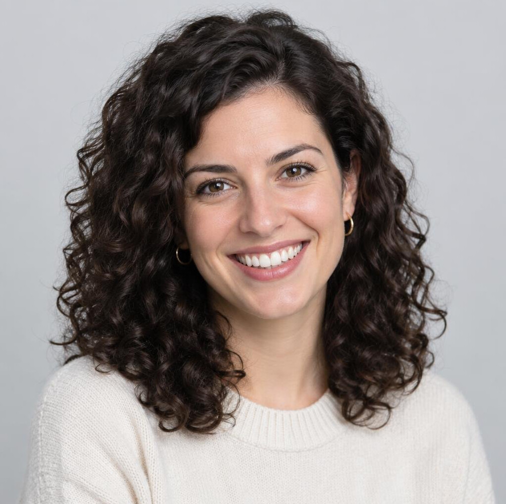 Studio portrait of a young woman with curly dark hair